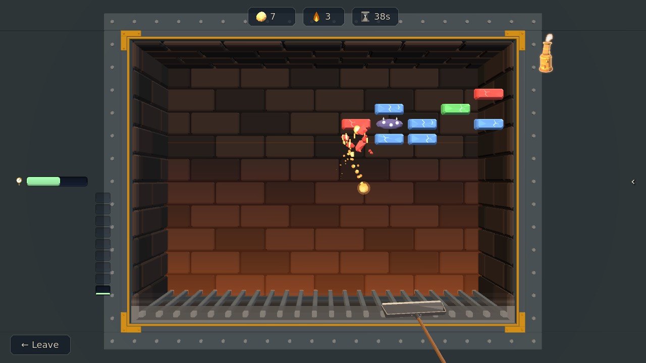 A red coal crumbling into burning bits as the ember drops away from it, blue and green coal still standing beside it